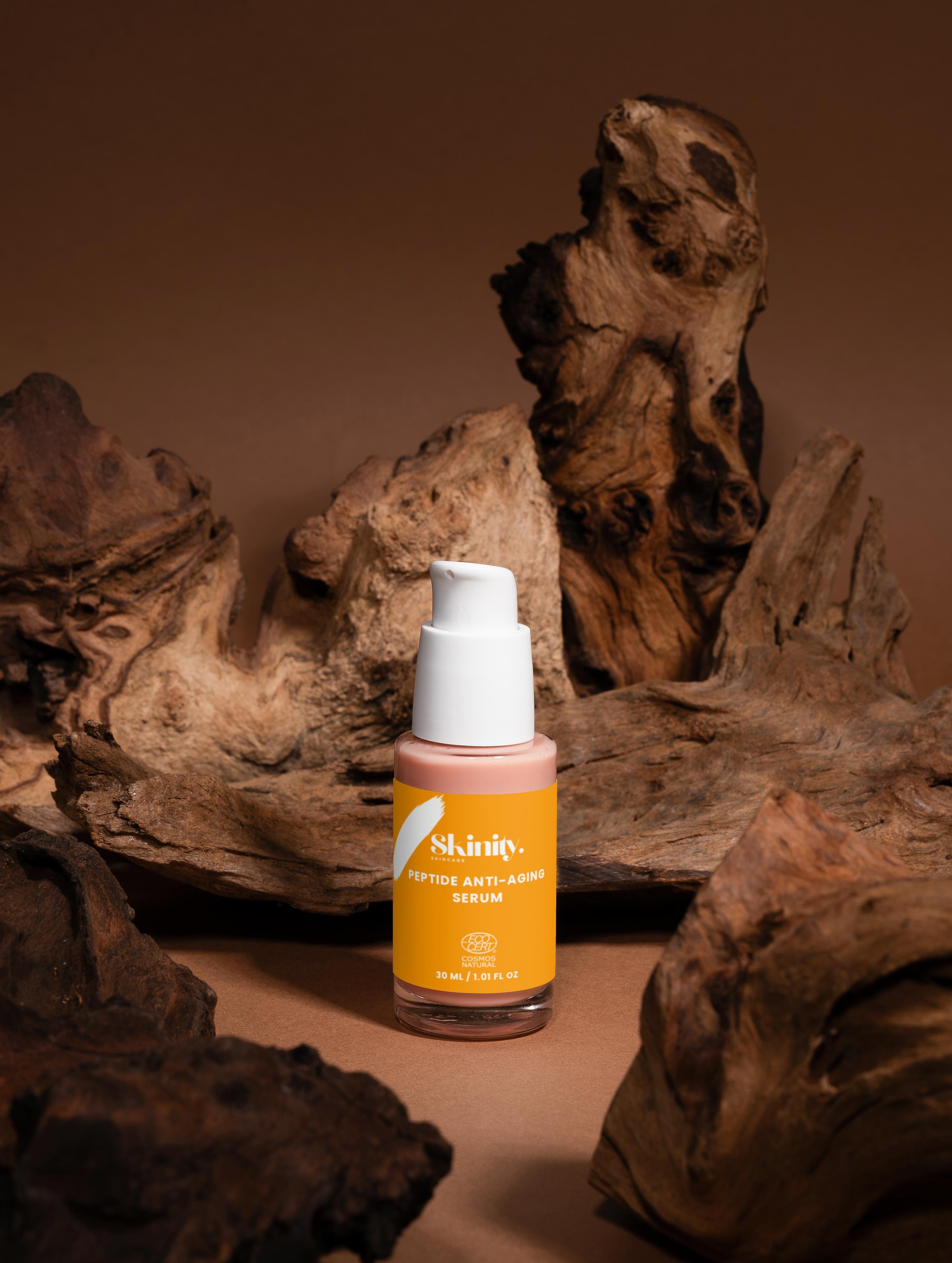 Peptide Anti-Aging Serum for All skincare in a scenic display with natural wood backdrop.