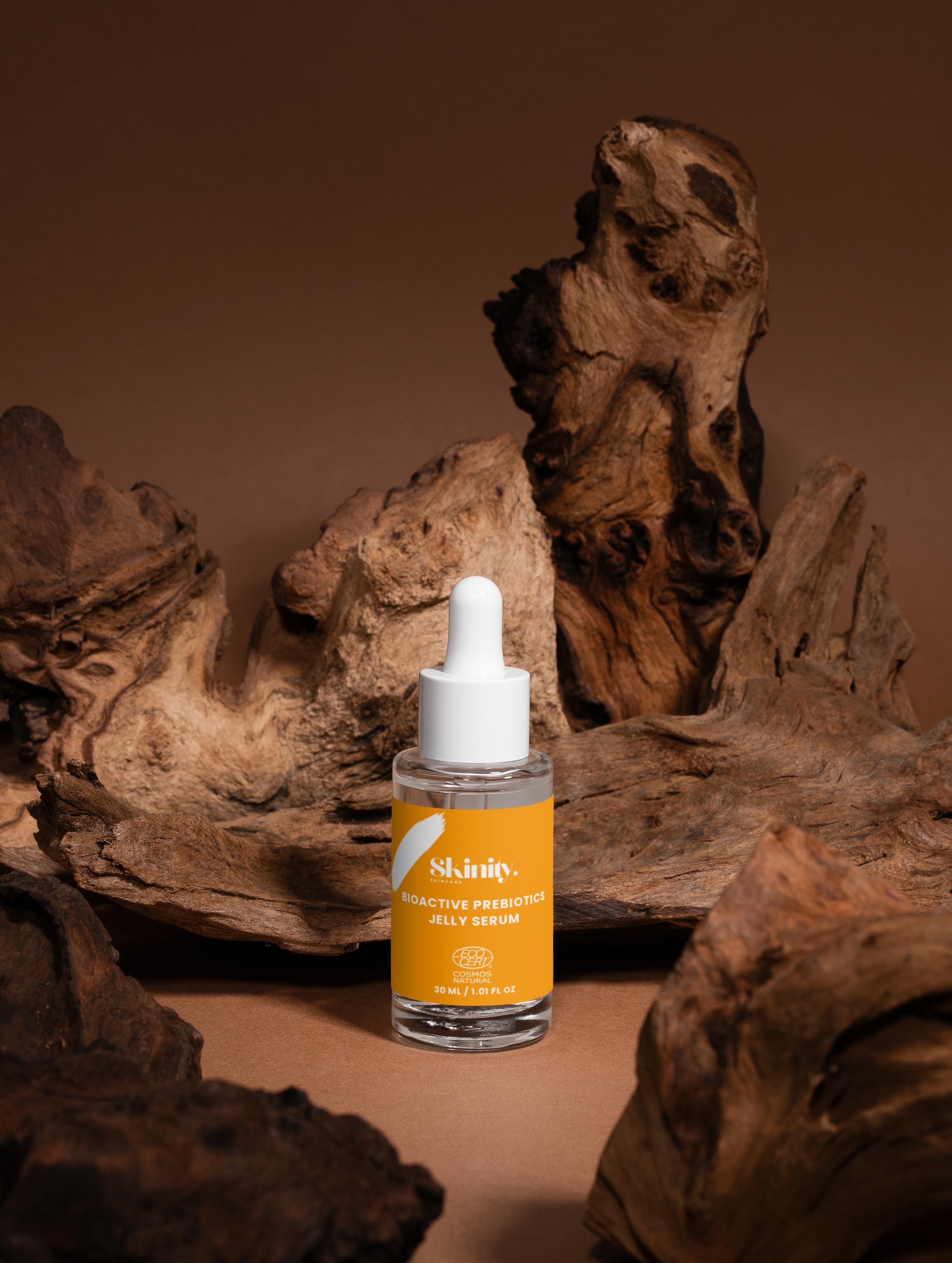 Bioactive Prebiotics Jelly Serum in a glass bottle with a dropper on a wooden surface
