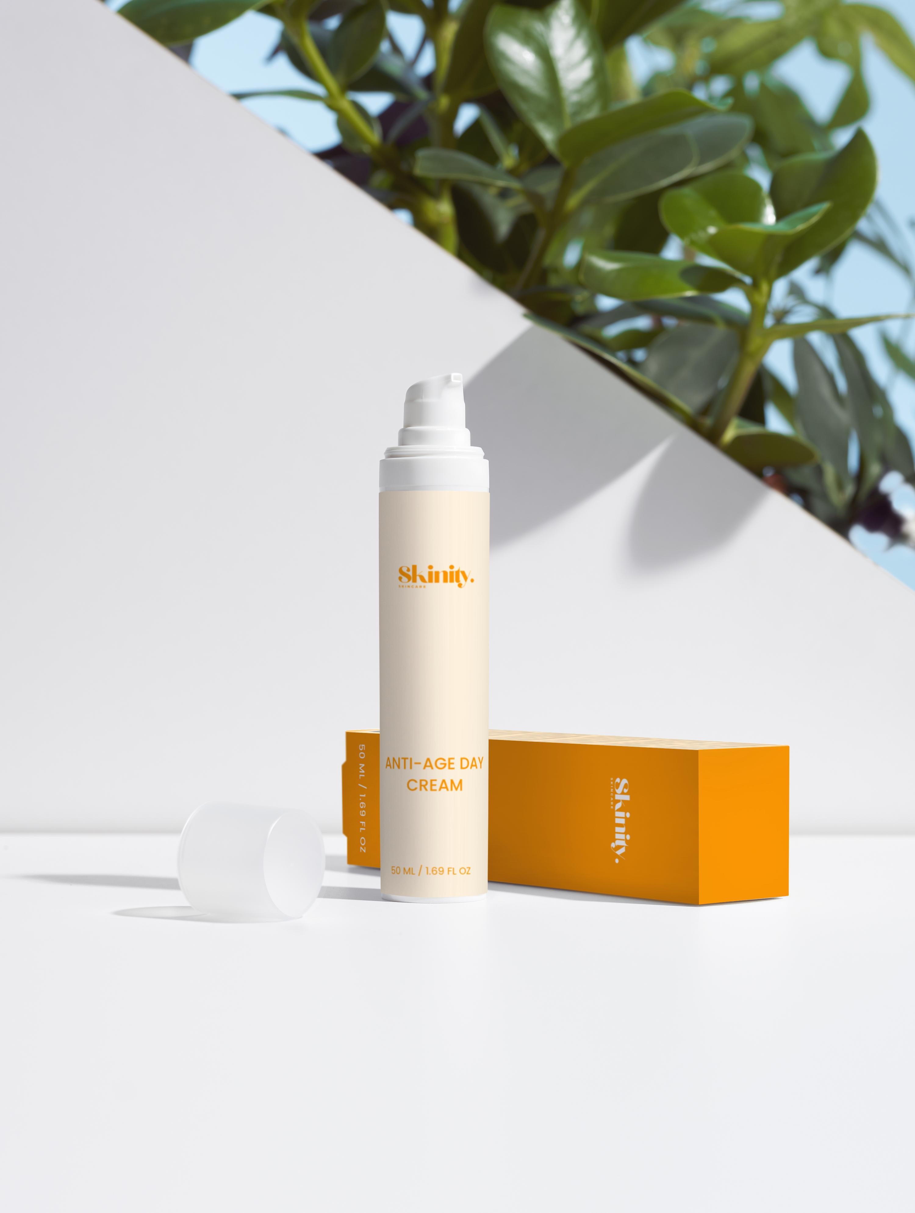 Anti-Age Day Cream For All Skin with elegant packaging on a clean surface, surrounded by greenery.