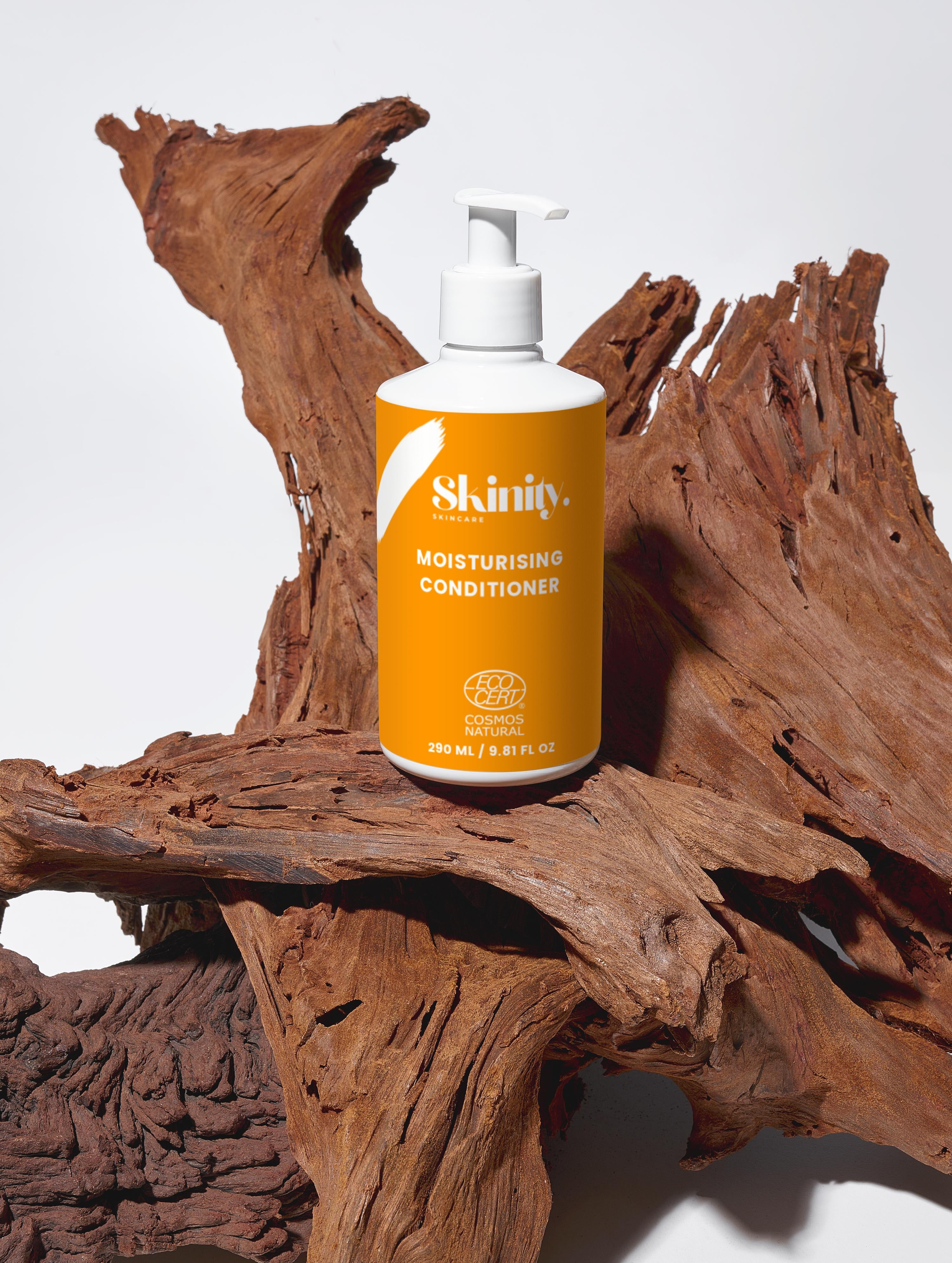 Moisturising Conditioner for all Hairs types in a white pump bottle on textured wood background