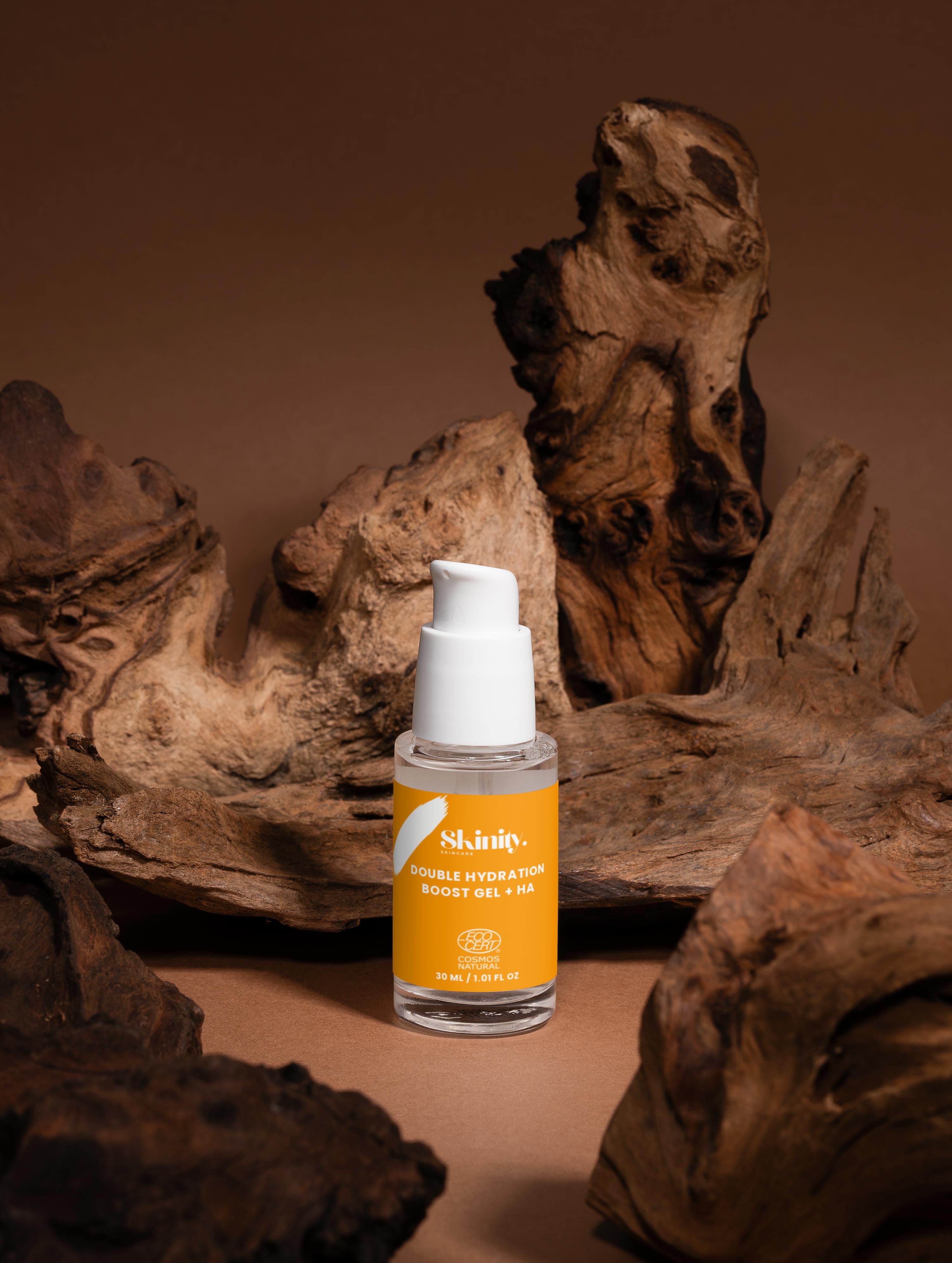 Double Hydration Boost Gel + HA in a clear bottle on rustic wooden background, promoting deep skin hydration.