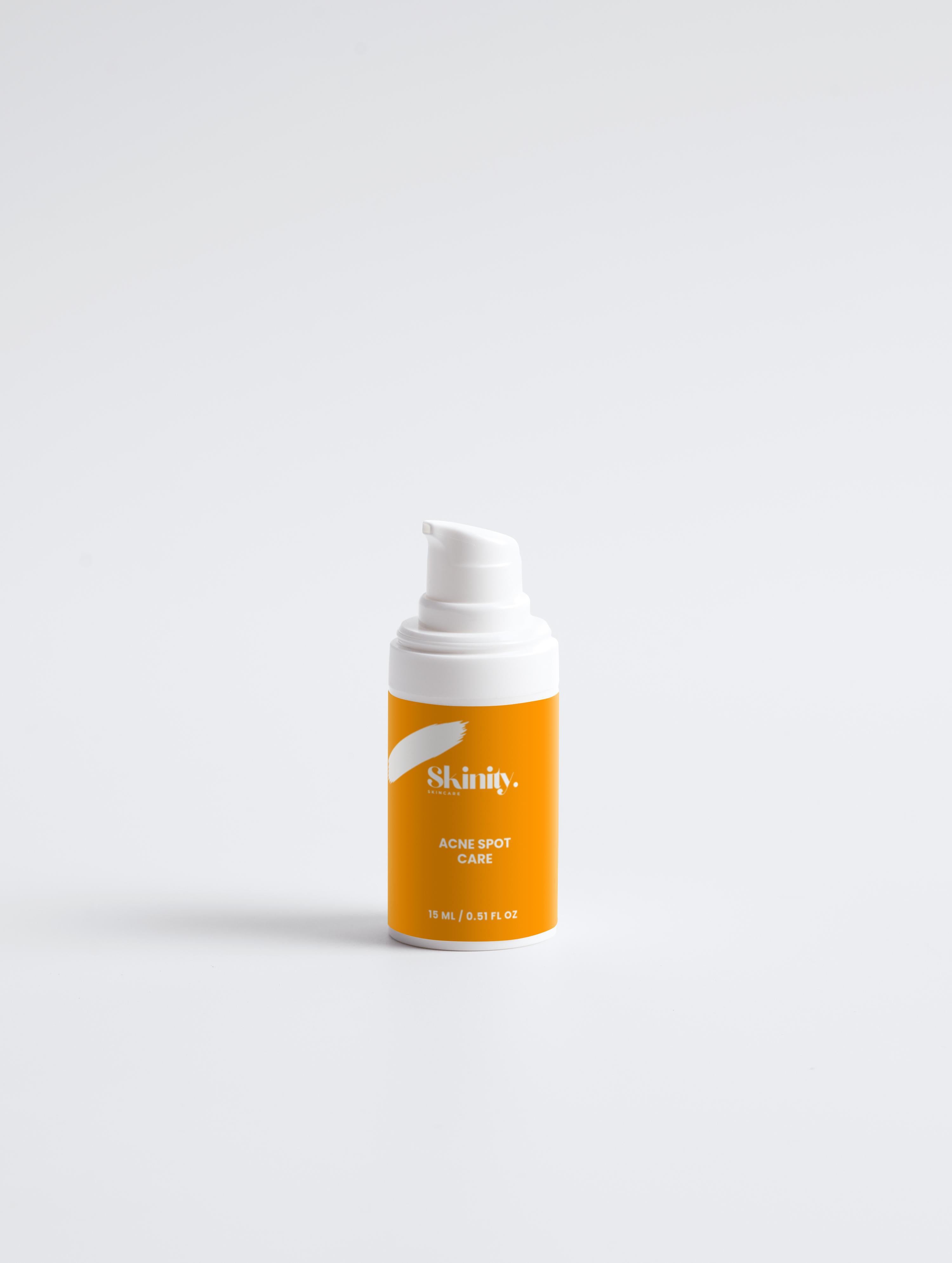 Acne Spot Care Serum for all skin types in a pump bottle with vibrant orange packaging.