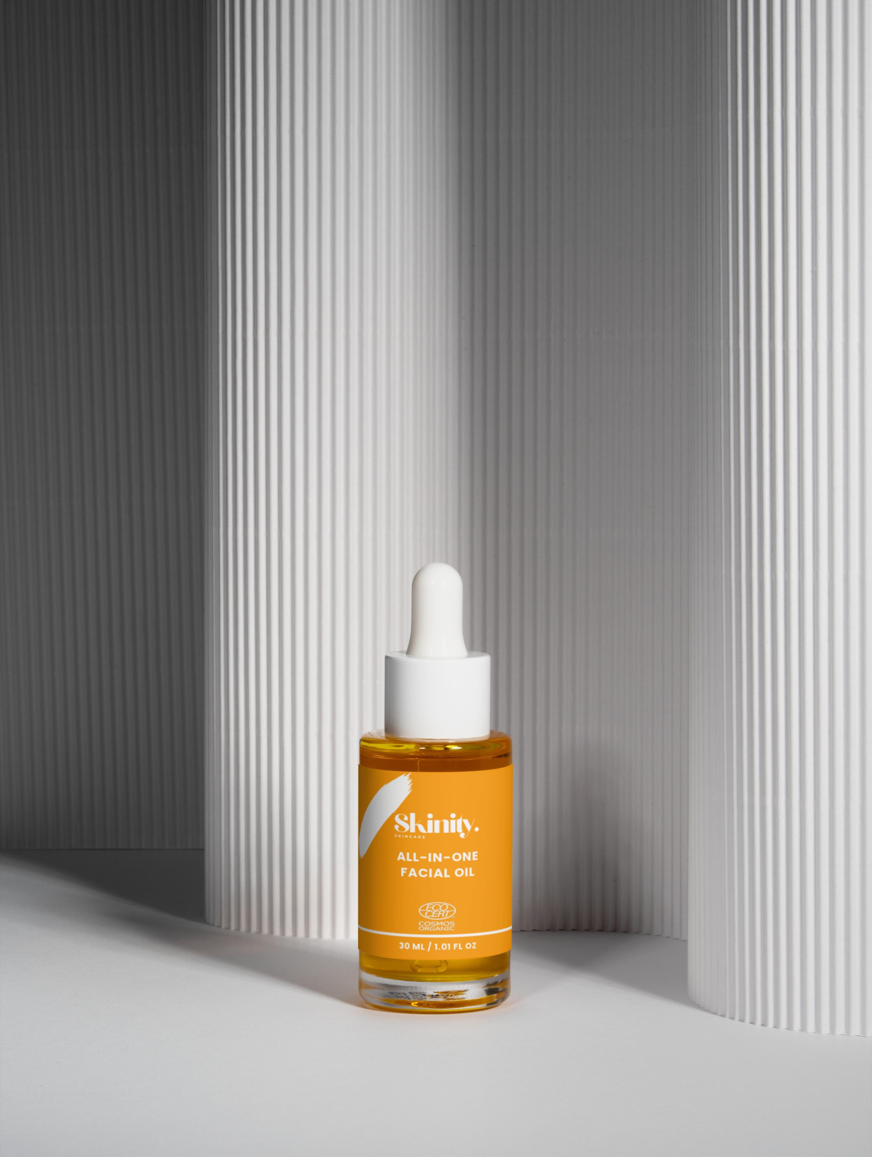All-In-One Facial Oil for all skin in a dropper bottle, enhancing hydration and radiance for all skin types.