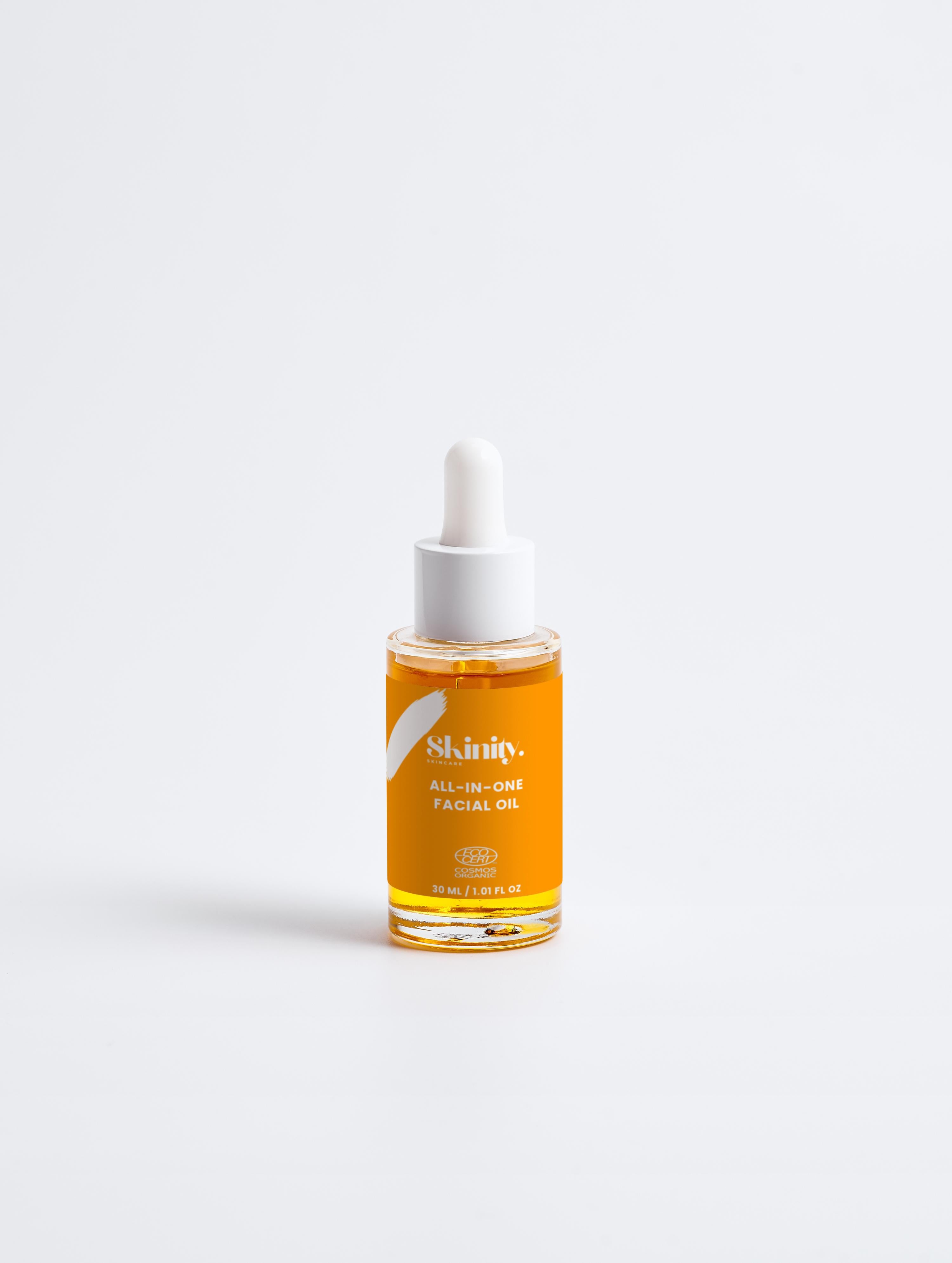 All-In-One Facial Oil for all skincare in a dropper bottle with an amber color, promoting hydration and glow.