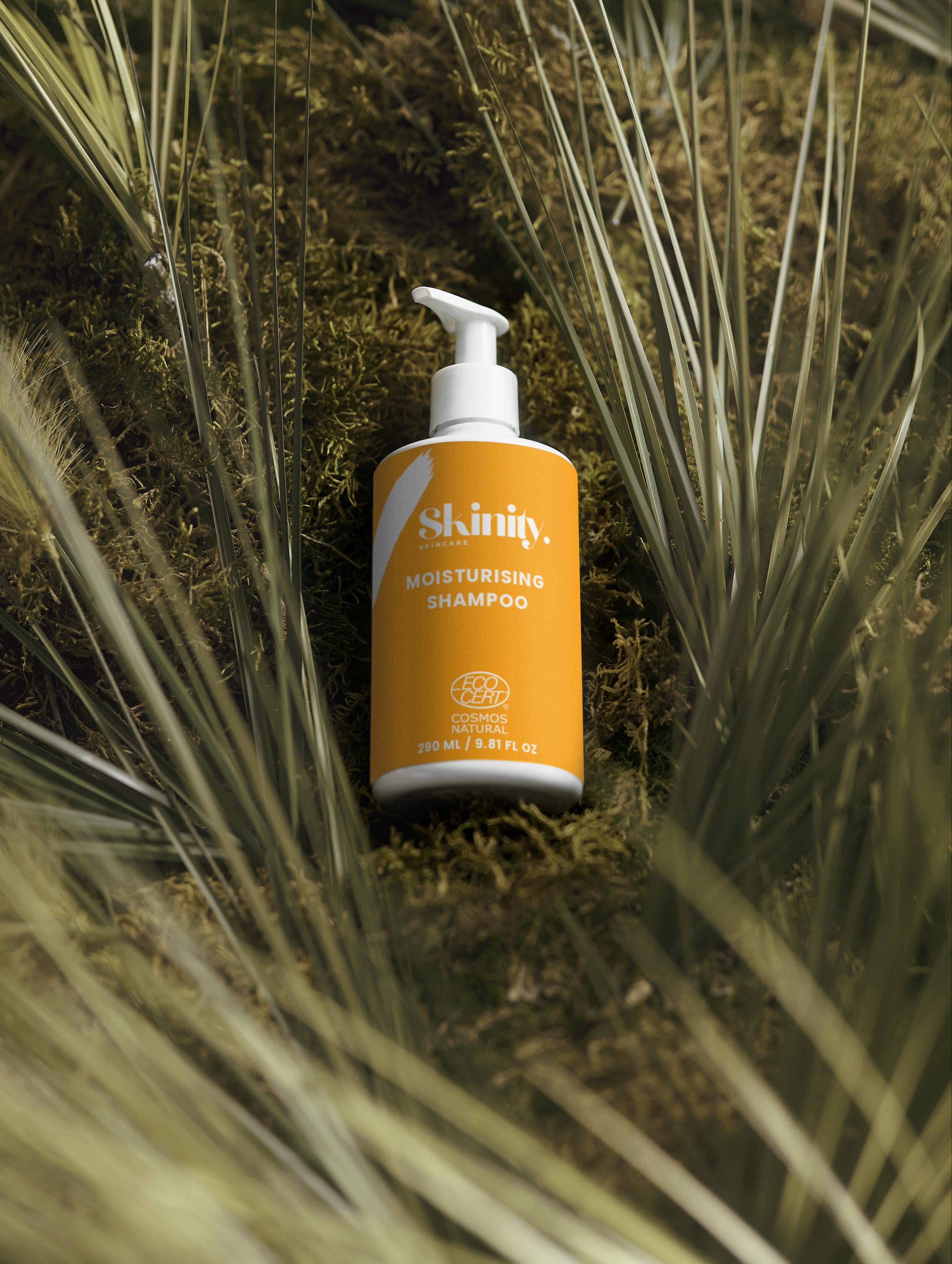 Moisturising Shampoo for all Hair types displayed on natural background with green plants.