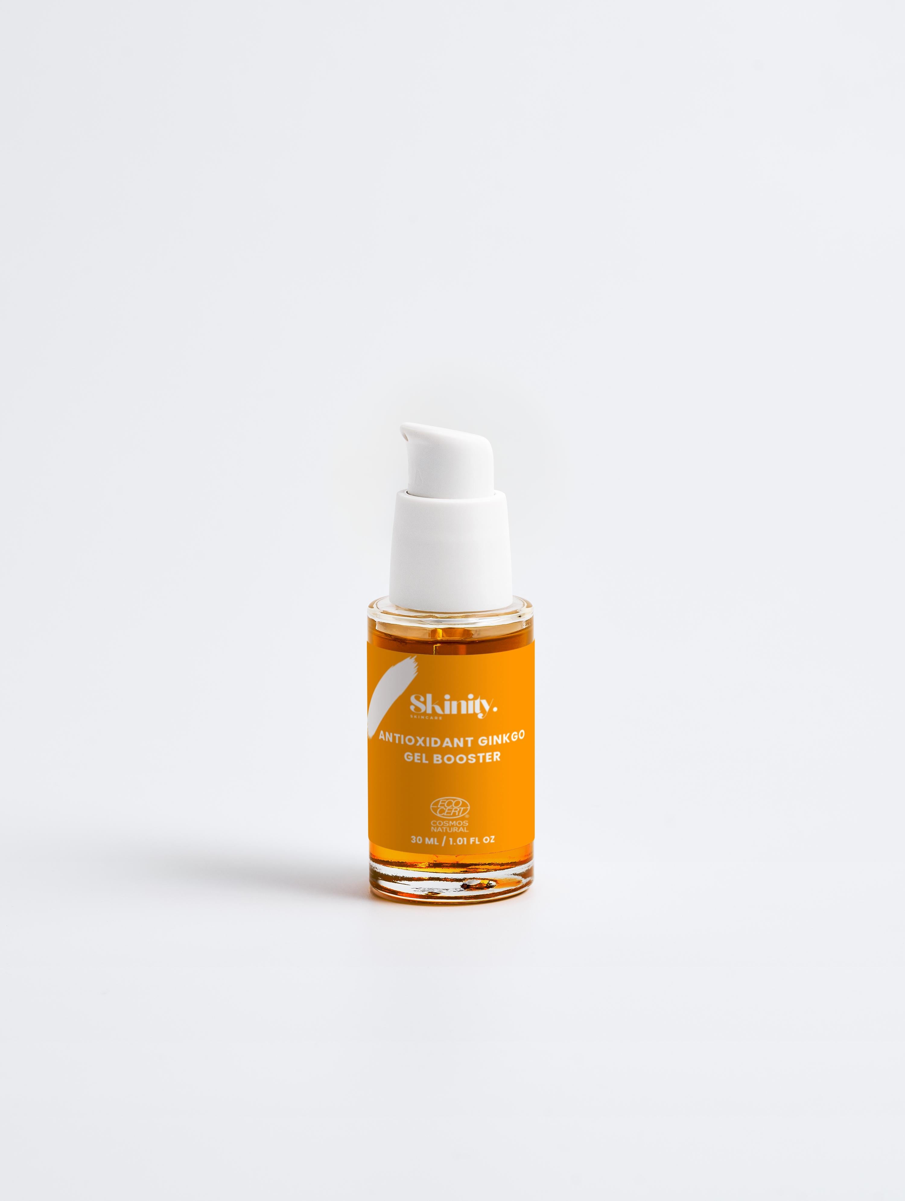 Antioxidant Ginkgo Gel Booster in a clear bottle with a pump, featuring an energizing orange gel formula for refreshing skin.