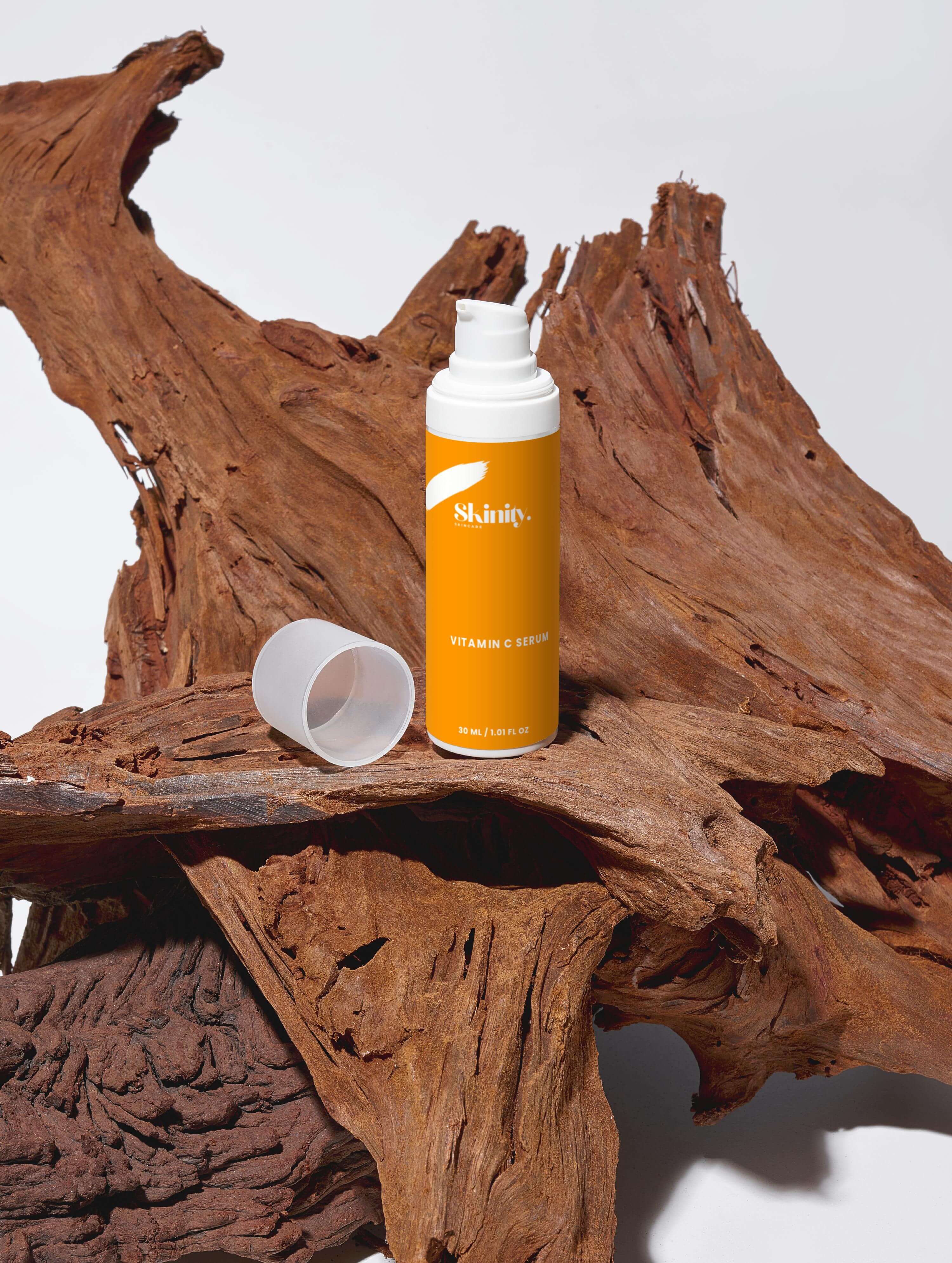 Vitamin C Serum for all skincare displayed on wooden surface, emphasizing its certified quality and vegan formula.