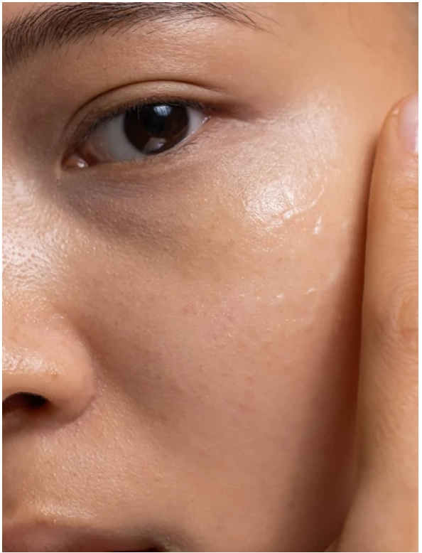 Close-up of a person applying Double Hydration Boost Gel + HA to the skin for deep hydration and rejuvenation.