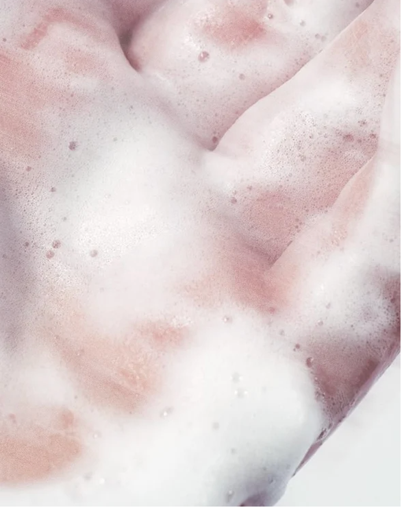 Hand and Body Wash Peppermint and Dark Cedar lathering foam on hands, showcasing its creamy texture and cleansing properties.