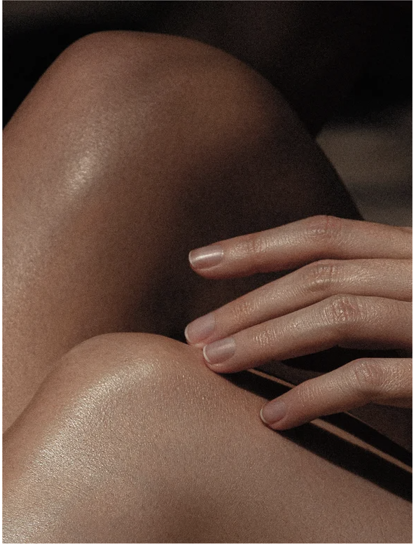 Icelandic Volcano Face and Body Scrub applied to smooth skin on knees and hands, showcasing healthy, revitalized appearance.