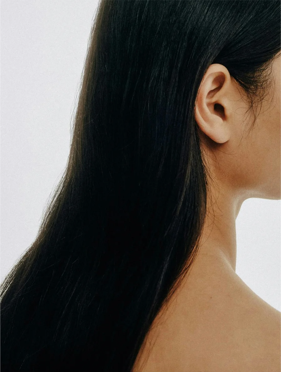 Close-up of smooth, shiny hair showcasing the benefits of Keratin Shine Leave In Hair Mist.