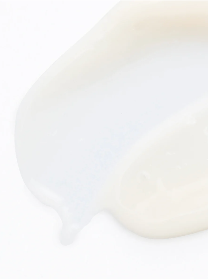 Pigment Perfecting Serum for All Skin, showcasing a creamy texture on a white background.