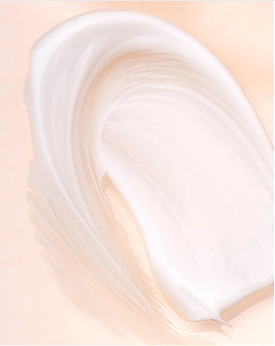 Natural retinol alternative eye serum smooth texture on a peach background.