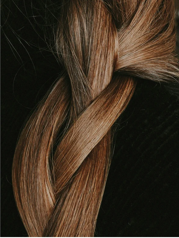 Close-up of a beautiful braided hairstyle showcasing shiny and healthy hair.