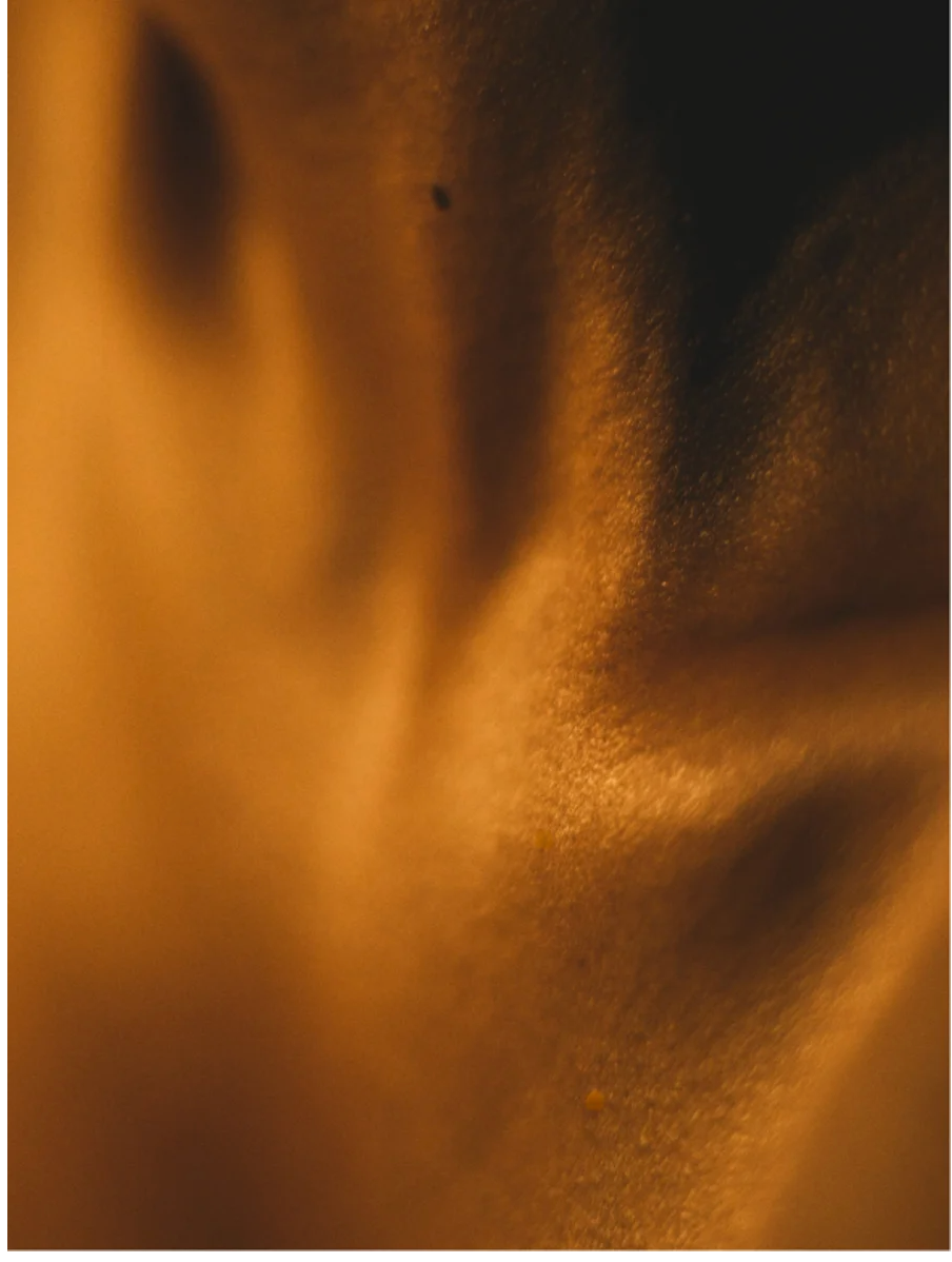 Silk Skin Body Serum Spices and Sandalwood texture and glow on smooth skin surface.