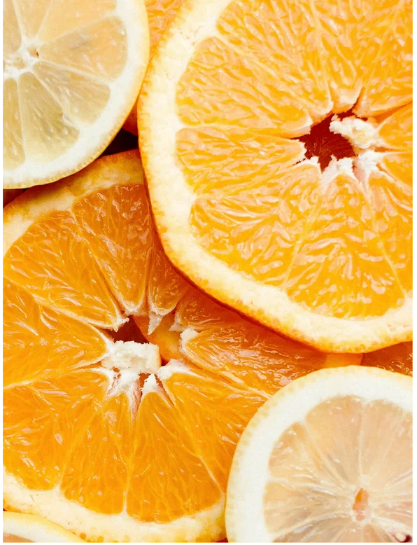 Fresh orange and lemon slices stacked together, showcasing vibrant colors and juicy textures.