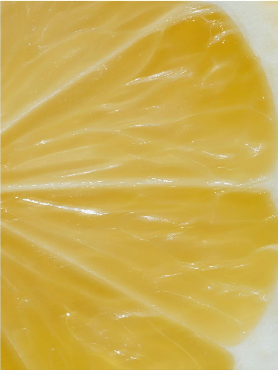 Close-up of a fresh lemon slice highlighting its juicy texture, ideal for vitamin C serum for all skincare.