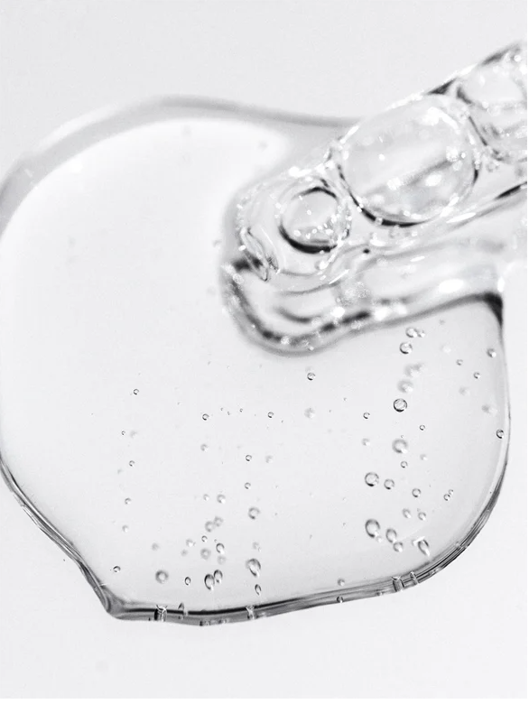 Bioactive Prebiotics Jelly Serum on a surface showing its clear, bubbly texture, highlighting its hydrating properties.