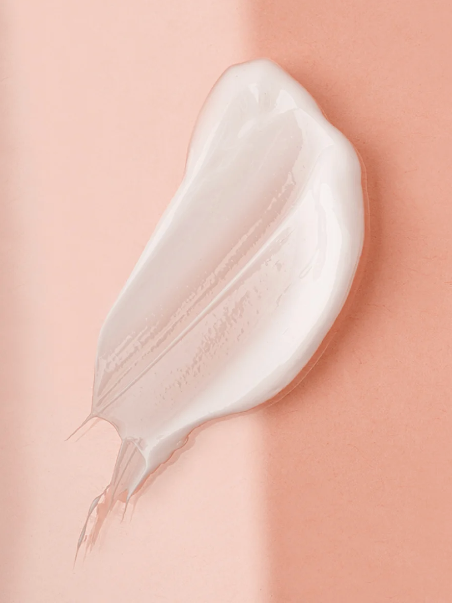 Collagen Boost Serum for All Skin swatch showcasing smooth, creamy texture on a soft pink background.