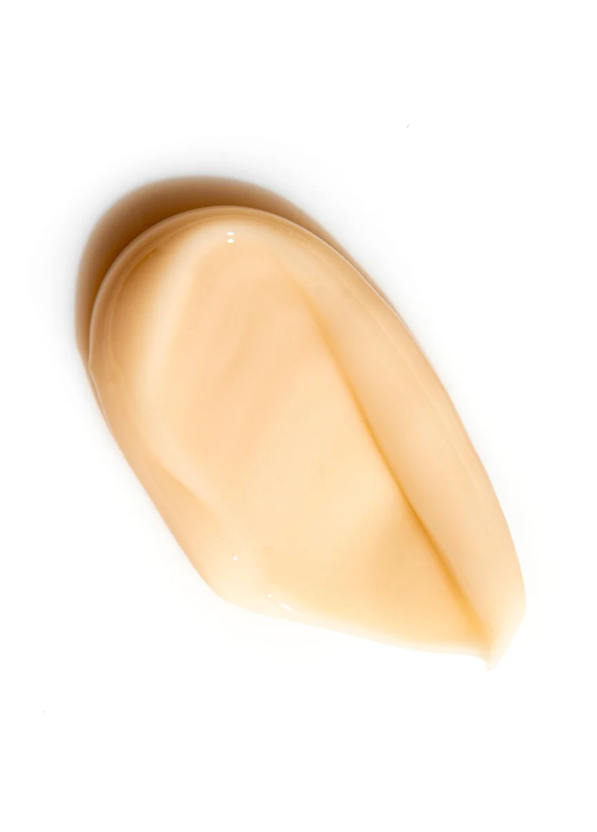 Creamy texture of Dark Spot Face Cream with Kojic Acid on a white background.