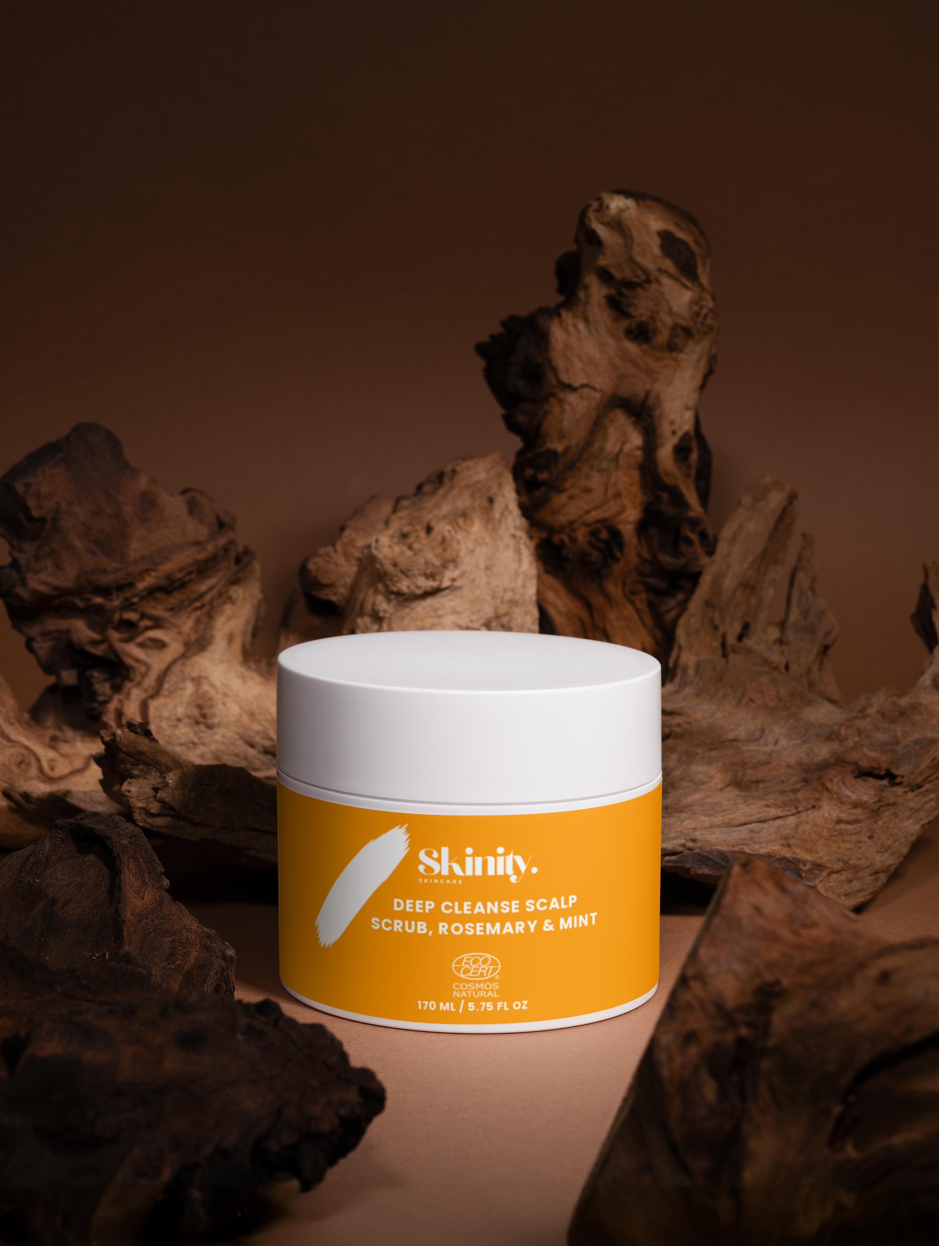 Deep Cleanse Scalp Scrub Rosemary and Mint in a yellow container placed on rustic wood background.