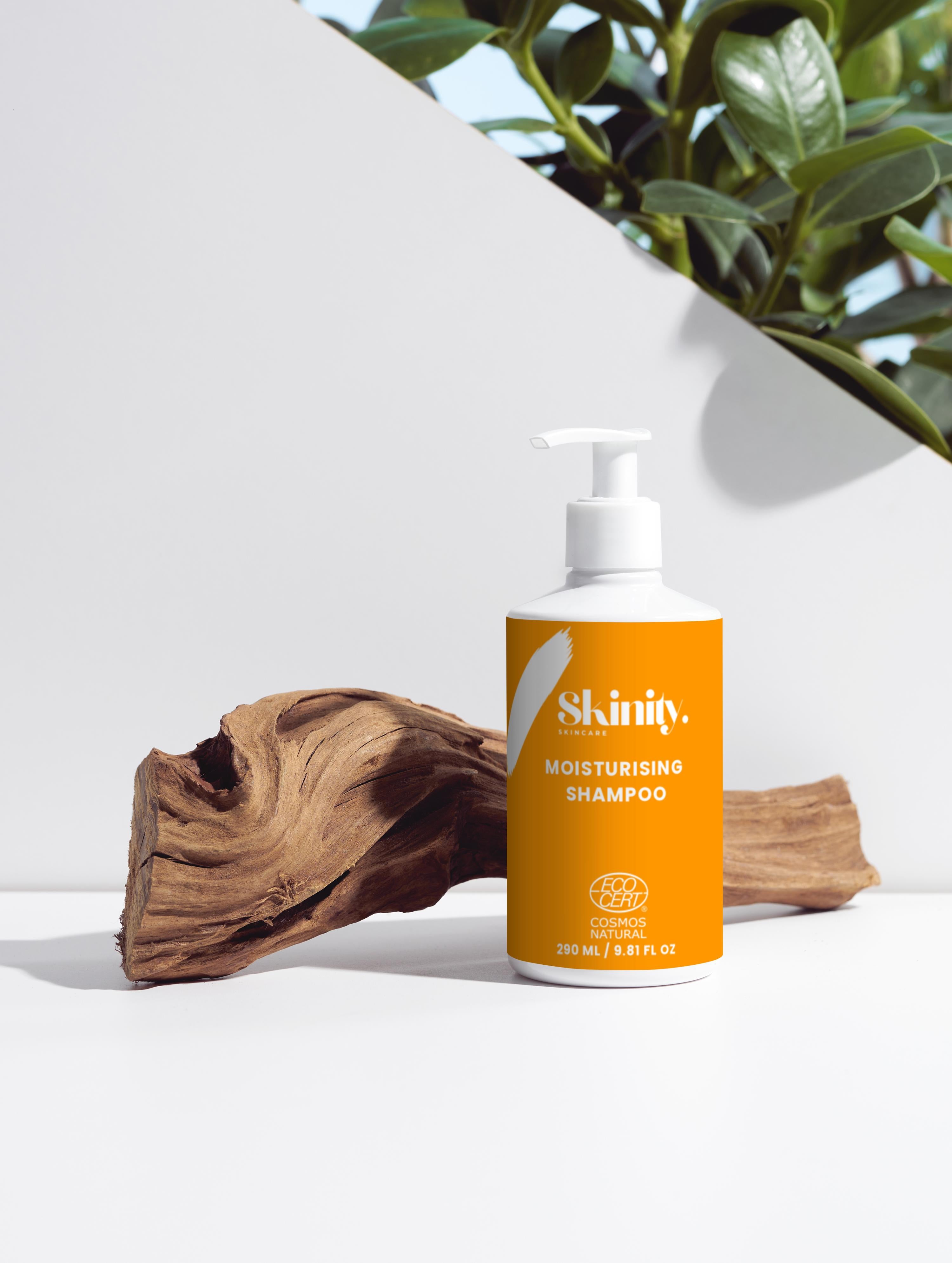 Moisturising Shampoo for all Hair types in a stylish bottle on a wooden surface with green plants.