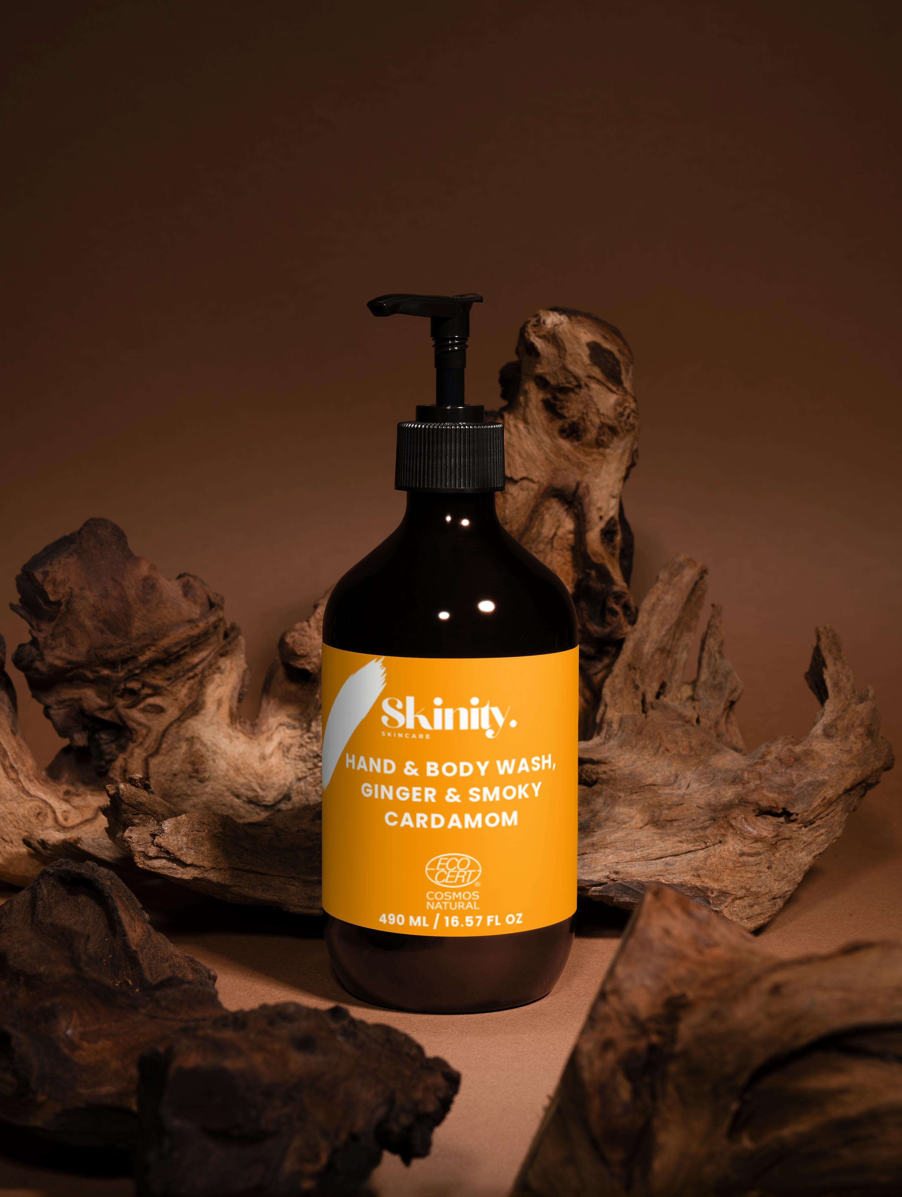 Hand and Body Wash Ginger and Smoky Cardamom bottle on wooden background for gentle cleansing and refreshing scent.