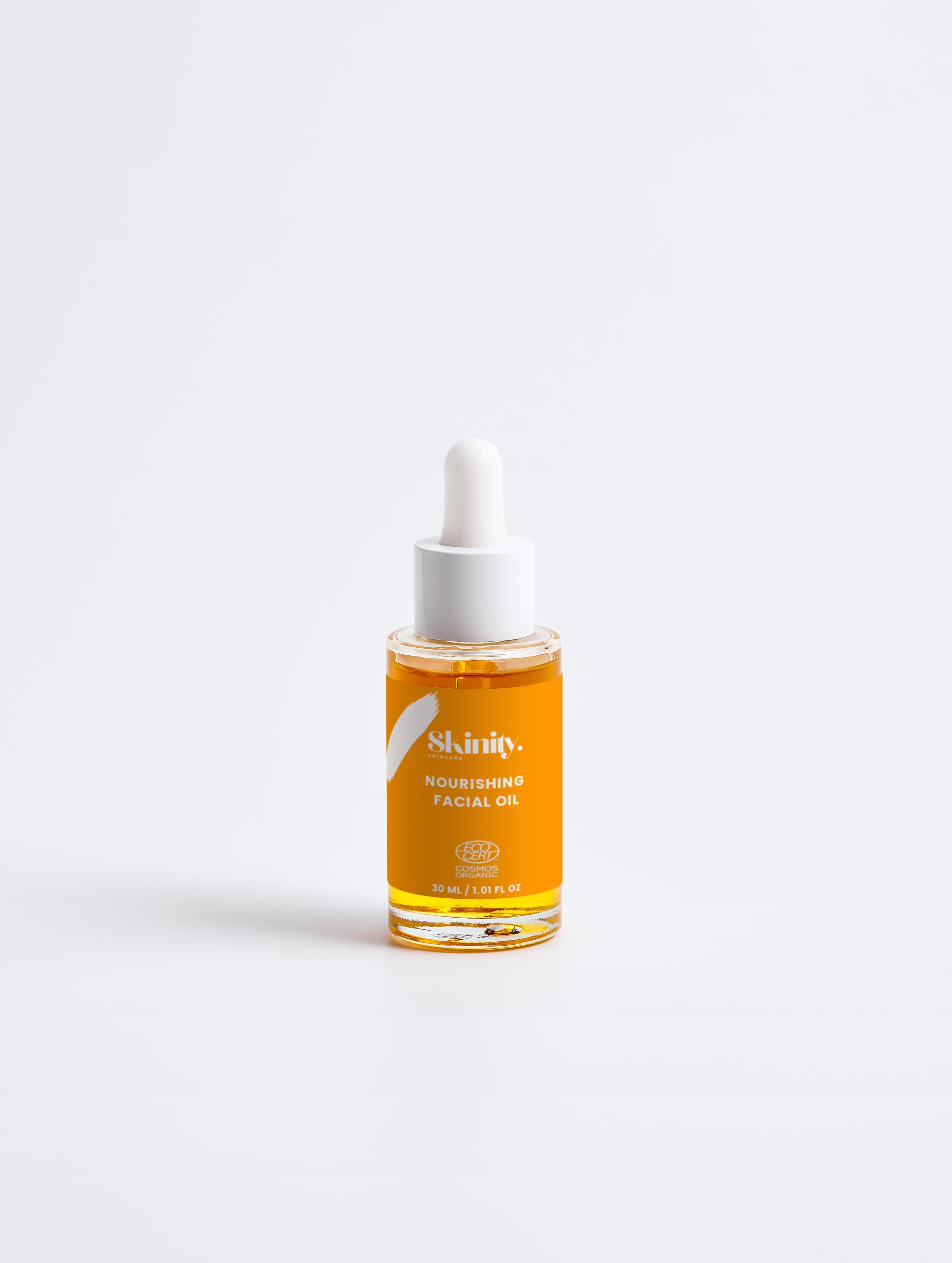 Nourishing Facial Oil For All Skin in a glass dropper bottle with a clean design on a white background.