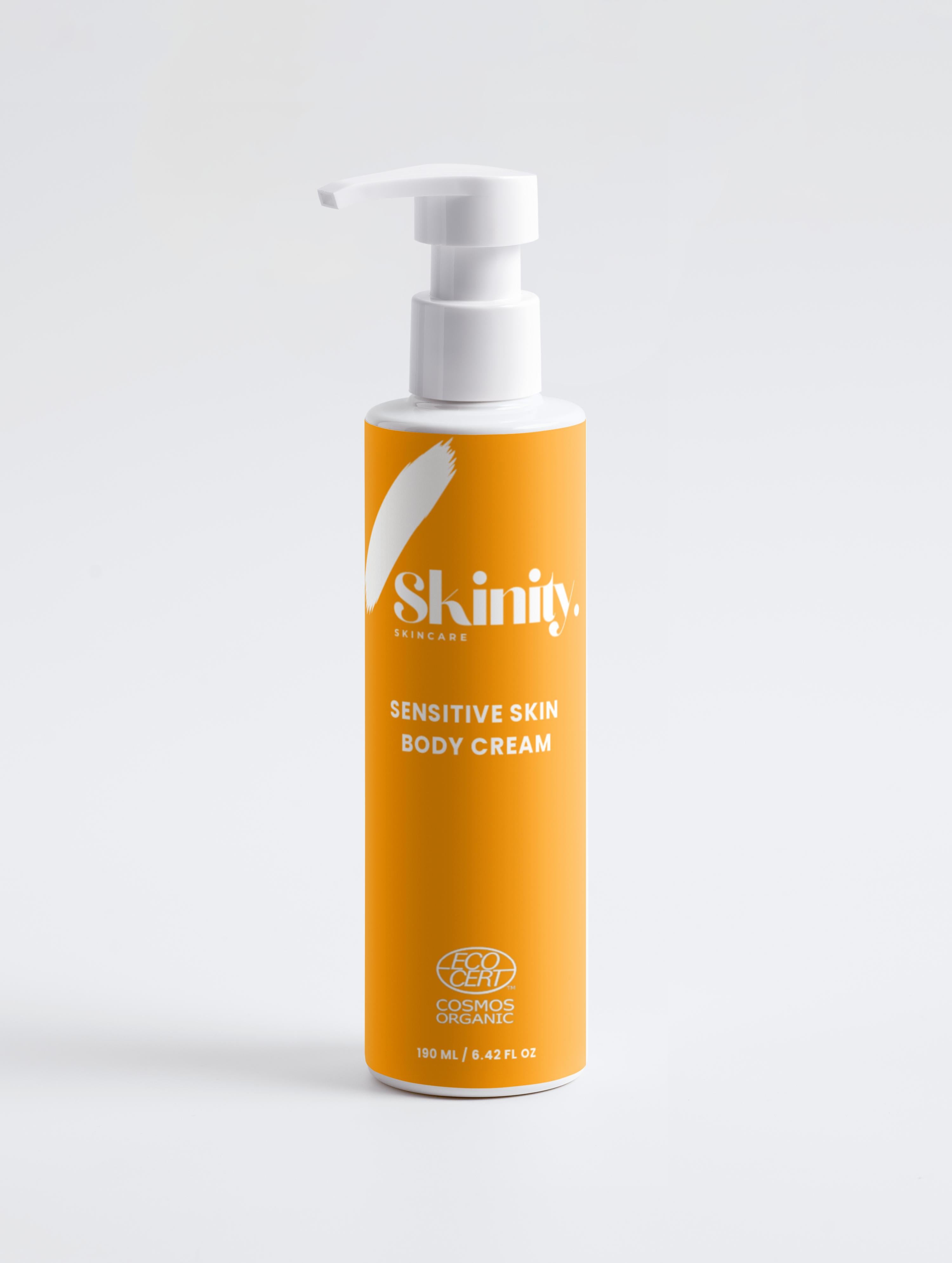 Sensitive Skin Body Cream Vegan in a sleek pump bottle with vibrant orange packaging for gentle hydration.