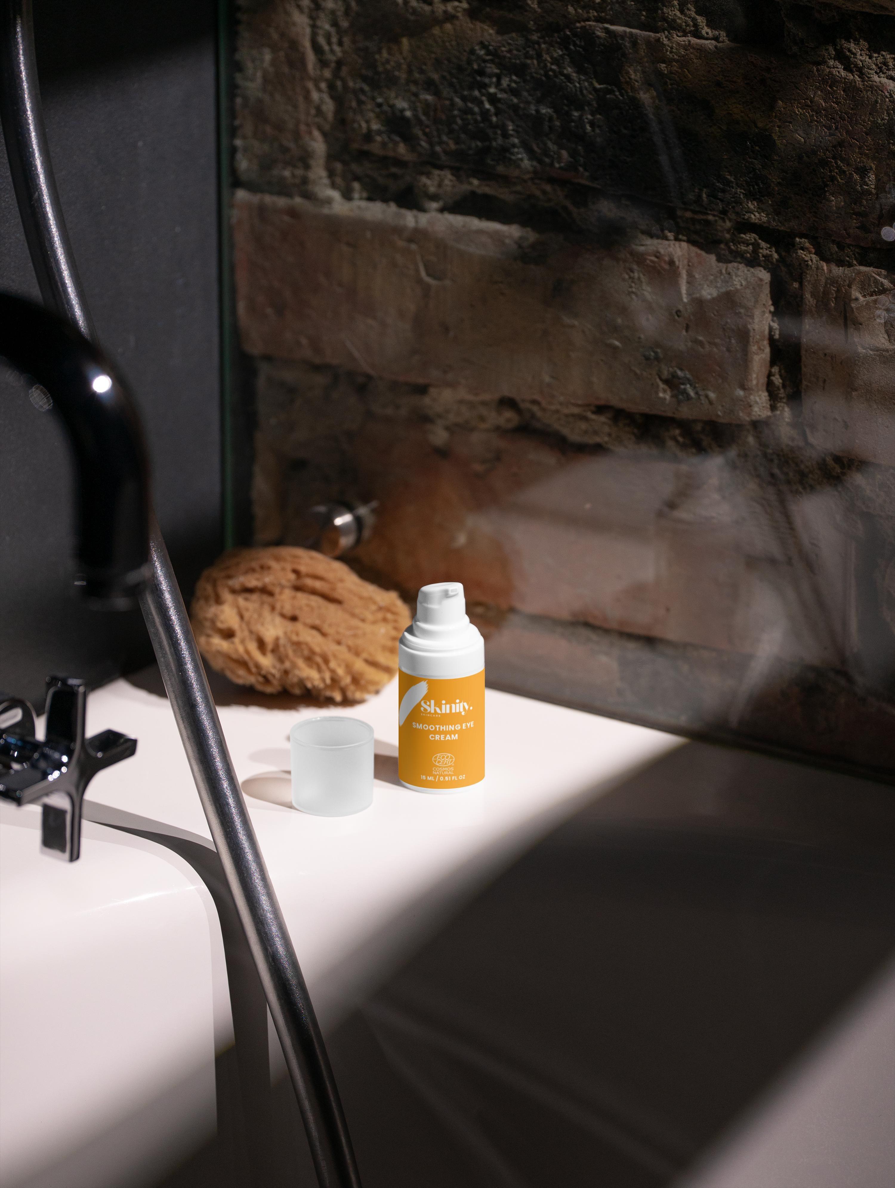 Smoothing eye cream bottle on a bathroom ledge beside a sponge, ideal for all skincare routines.